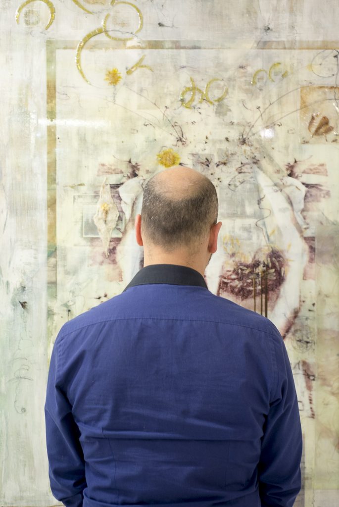 man looking at artwork in a gallery