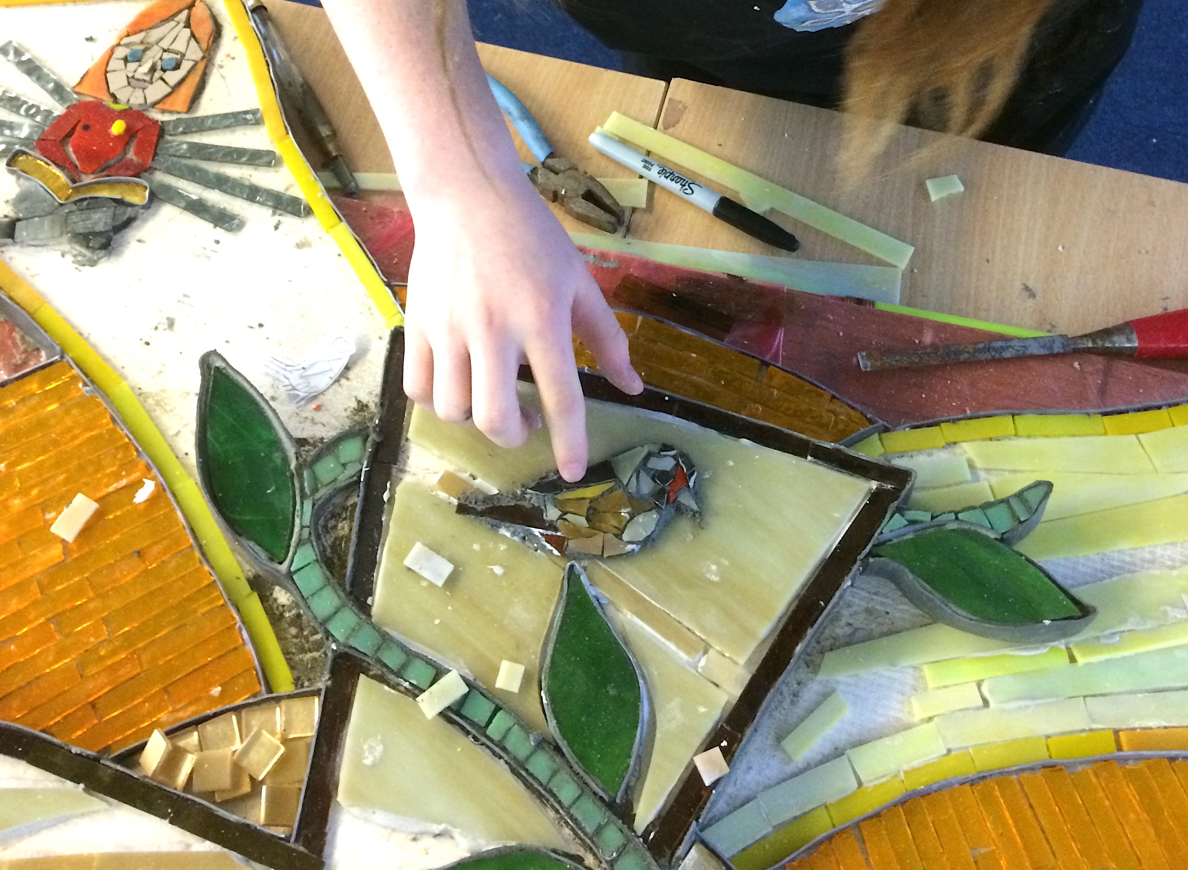 a girl making a mosaic