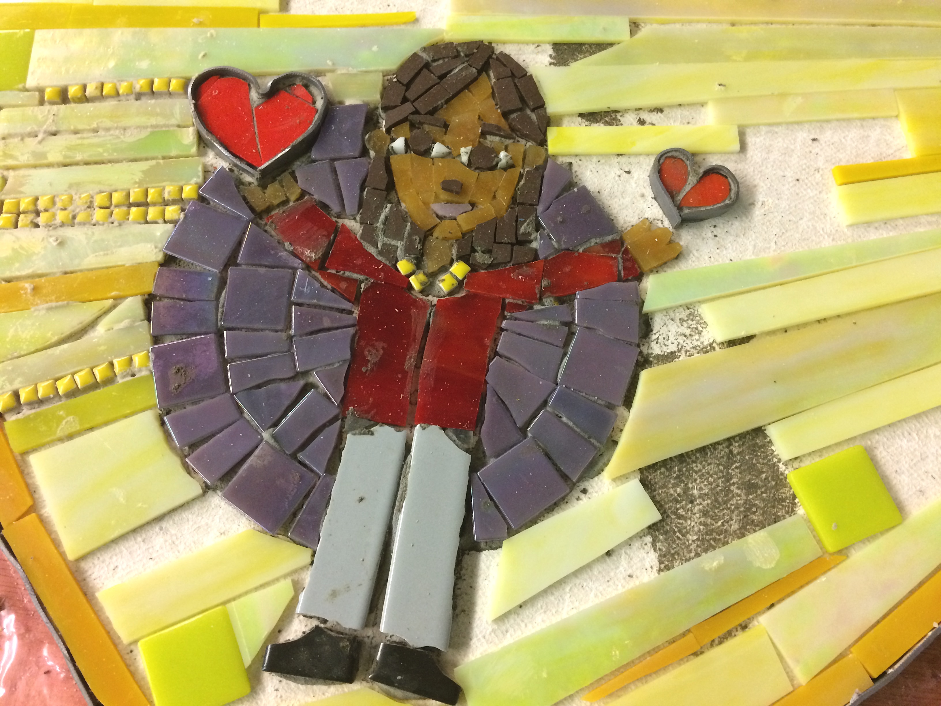 mosaic of a girl holding hearts in her hands