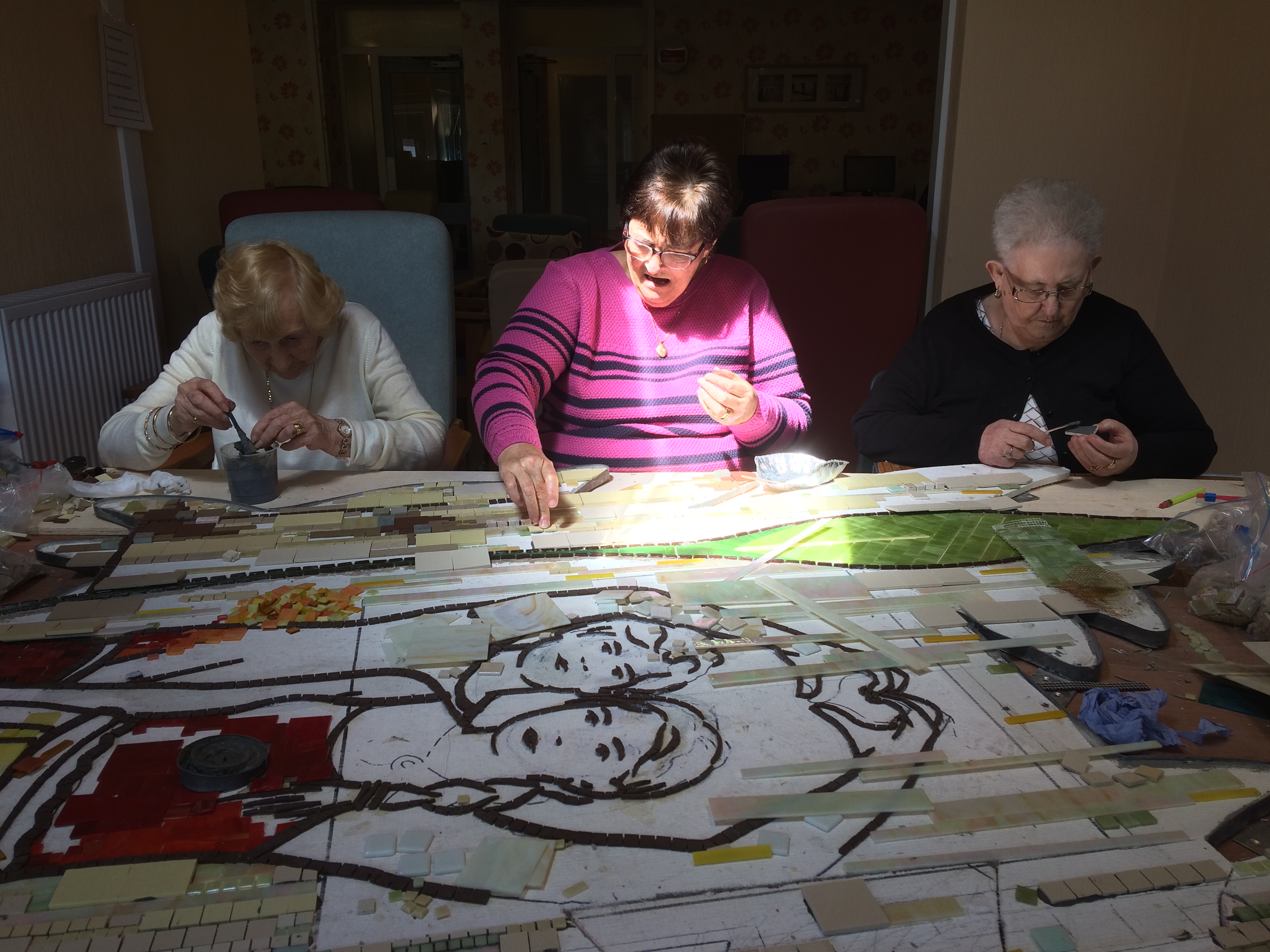 3 women making a mosaic