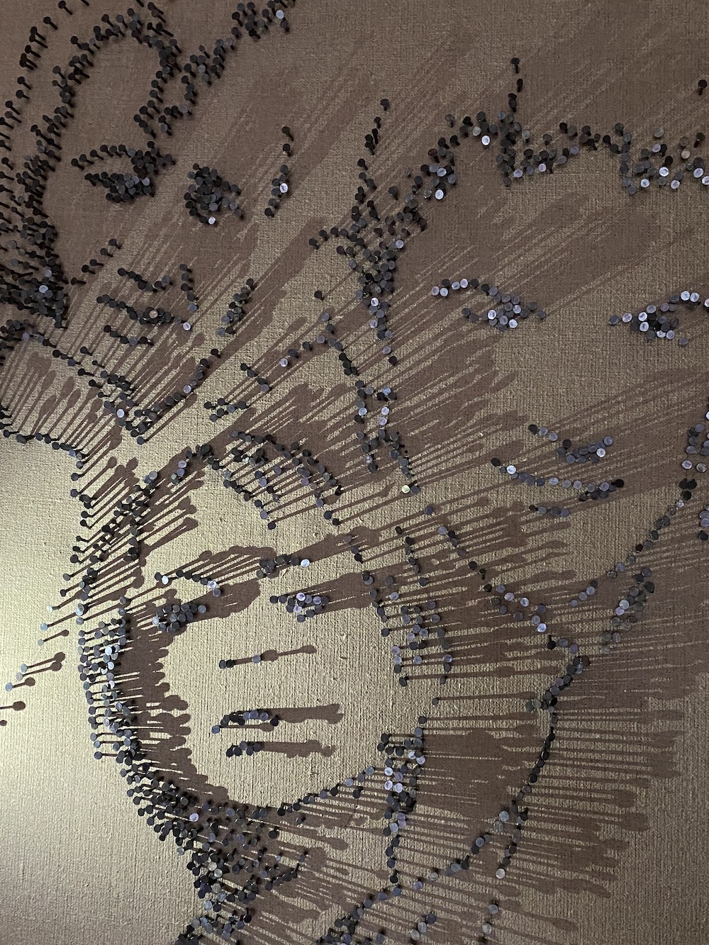 artwork of faces made of nails