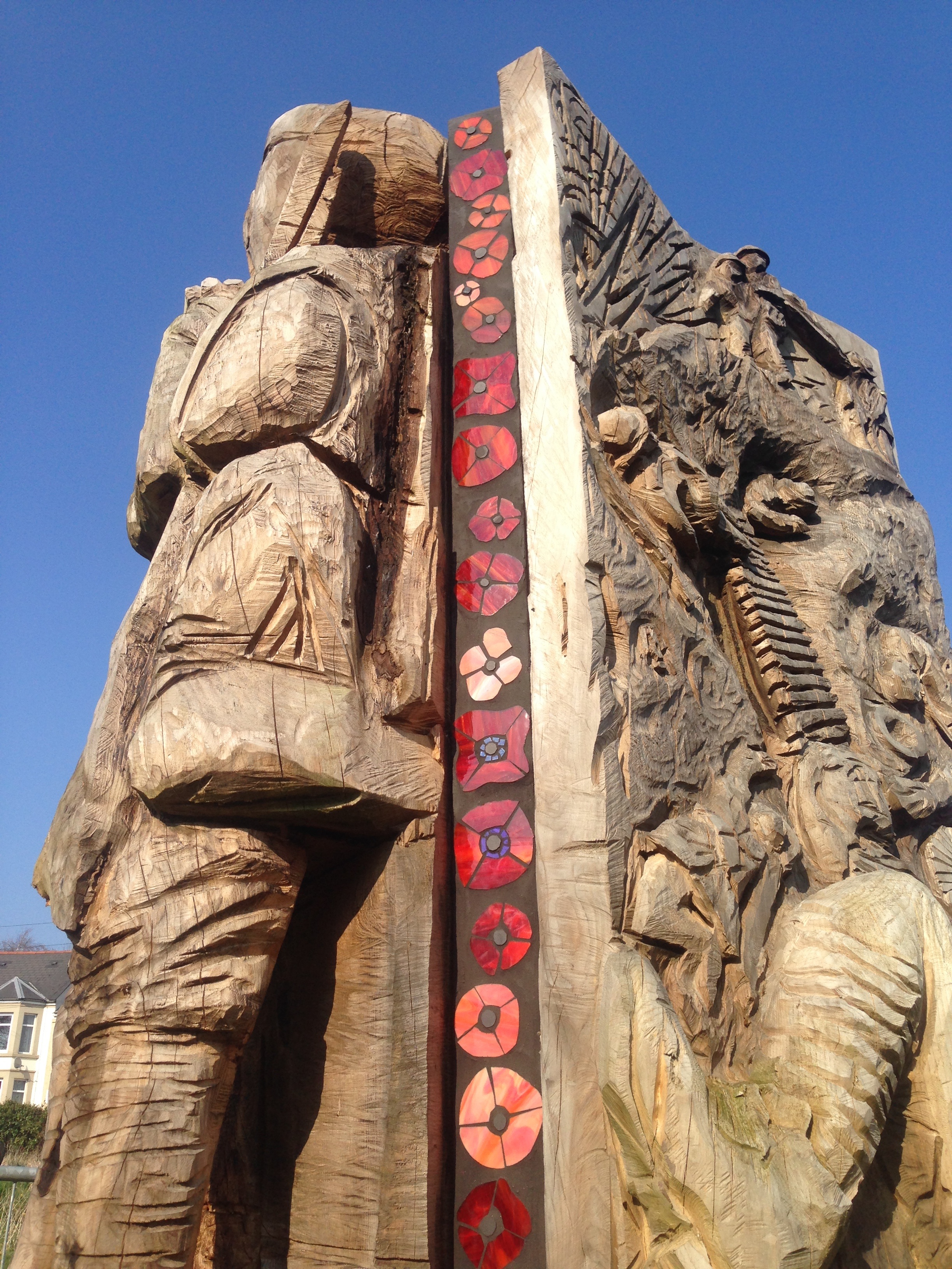 glass poppies on a wood sculpture