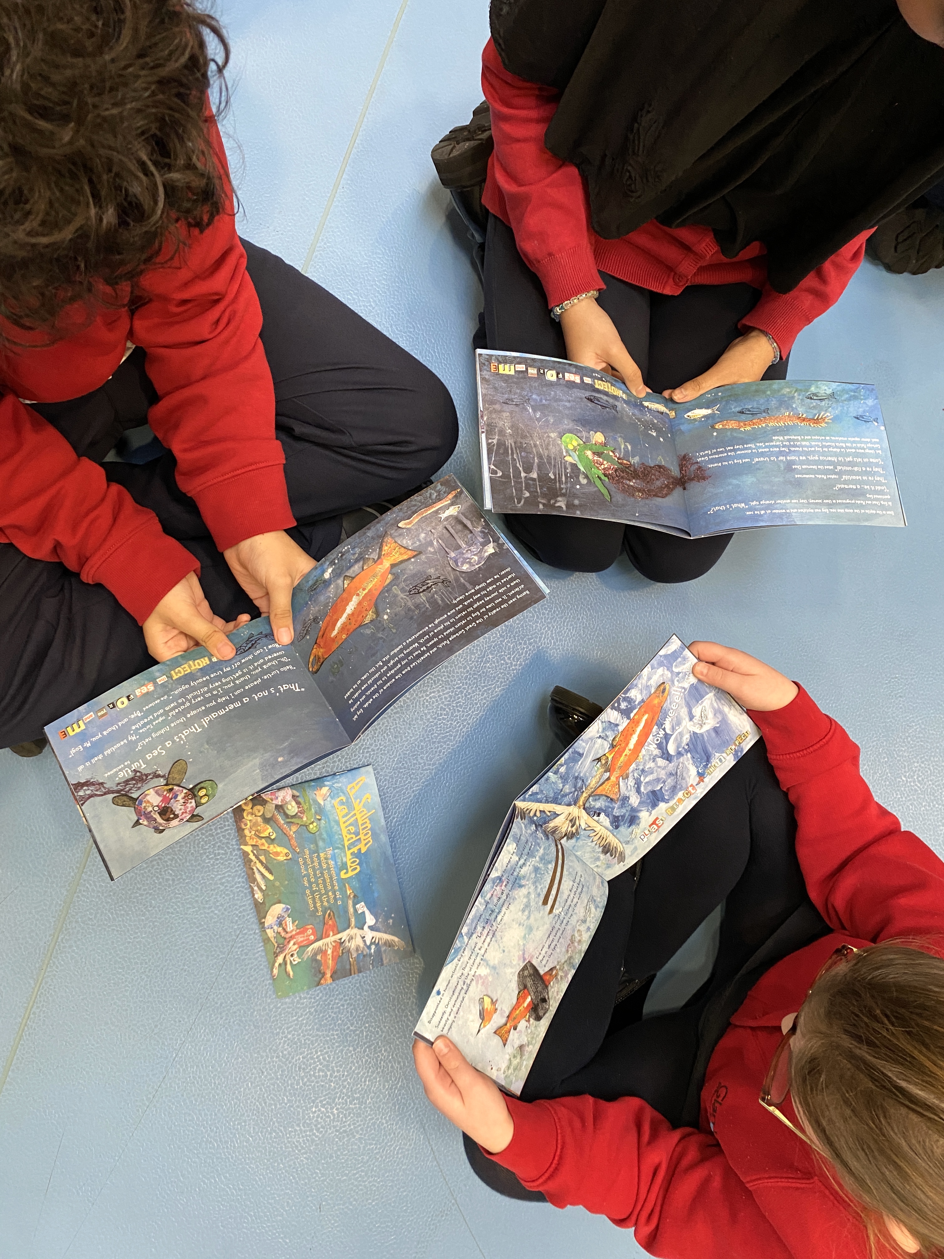 children reading their own made book.