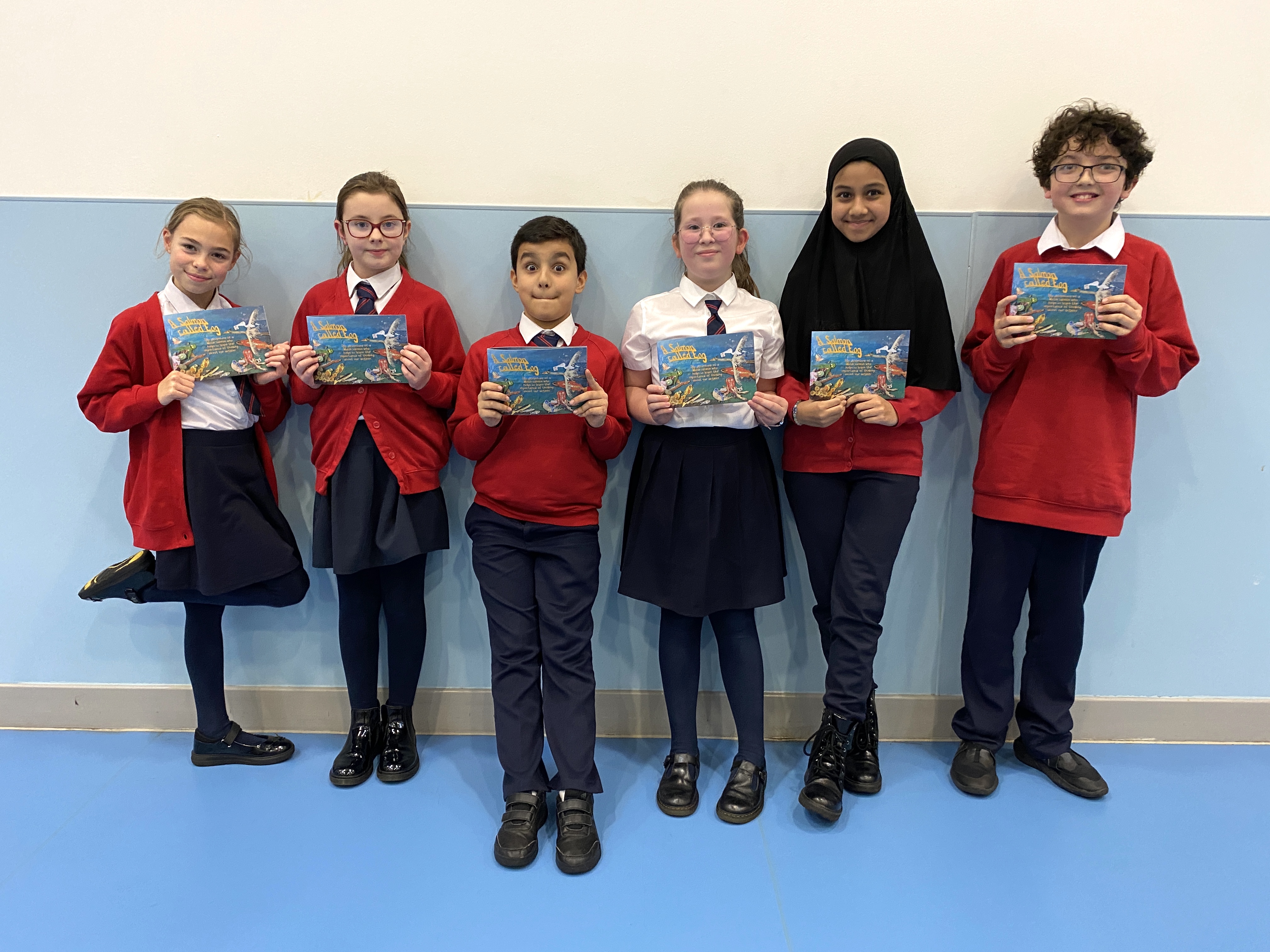 A group of pupils holding  books they have made