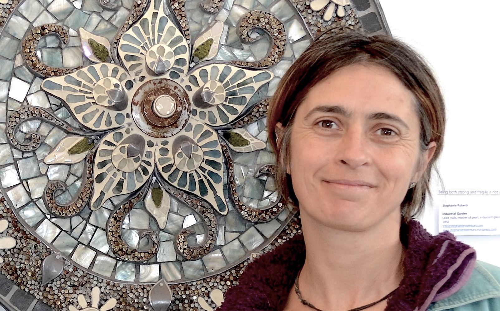artist with her mosaic work