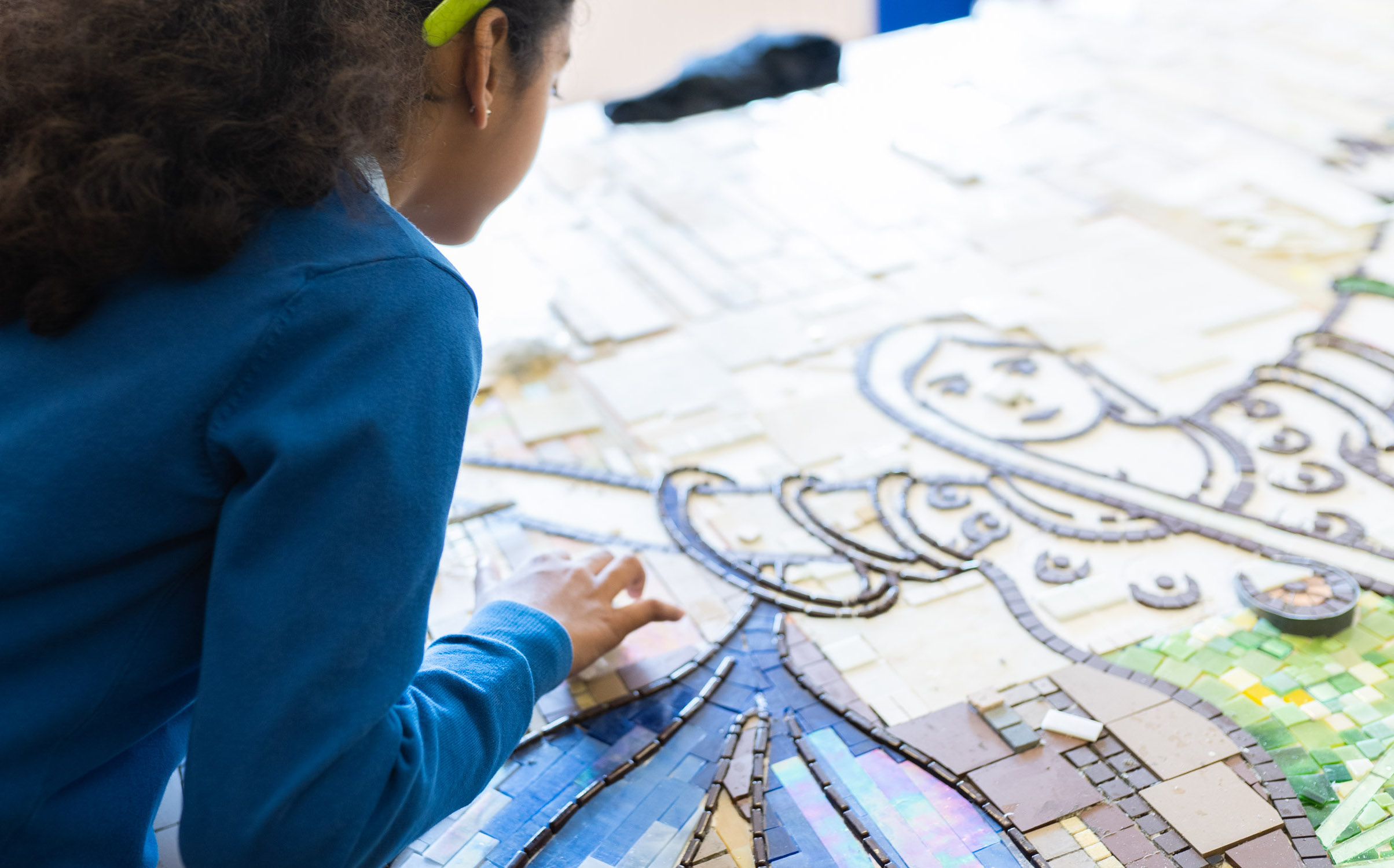 girl making a mosaic of a women from Newport history