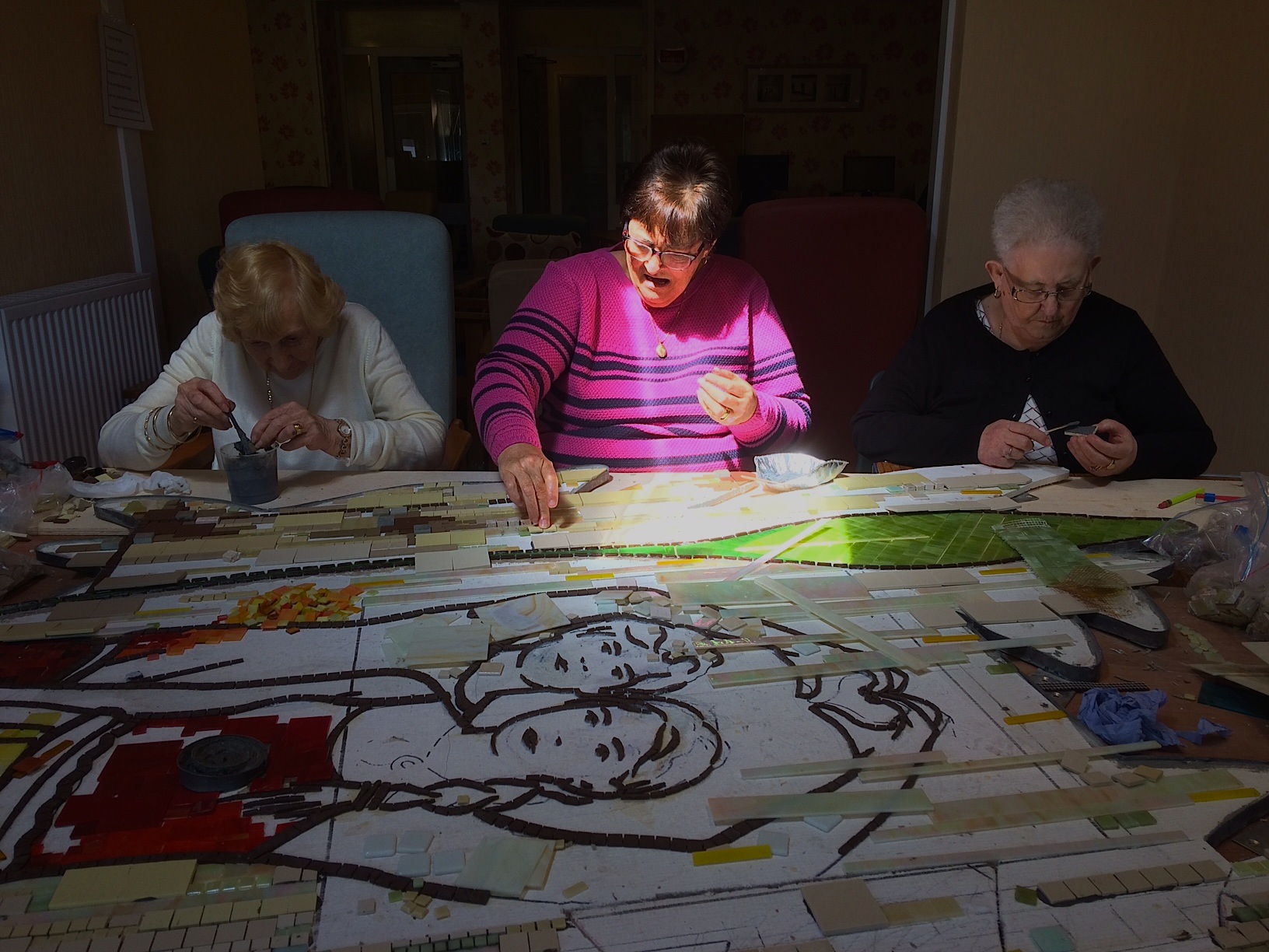 3 ladies making a mosaic