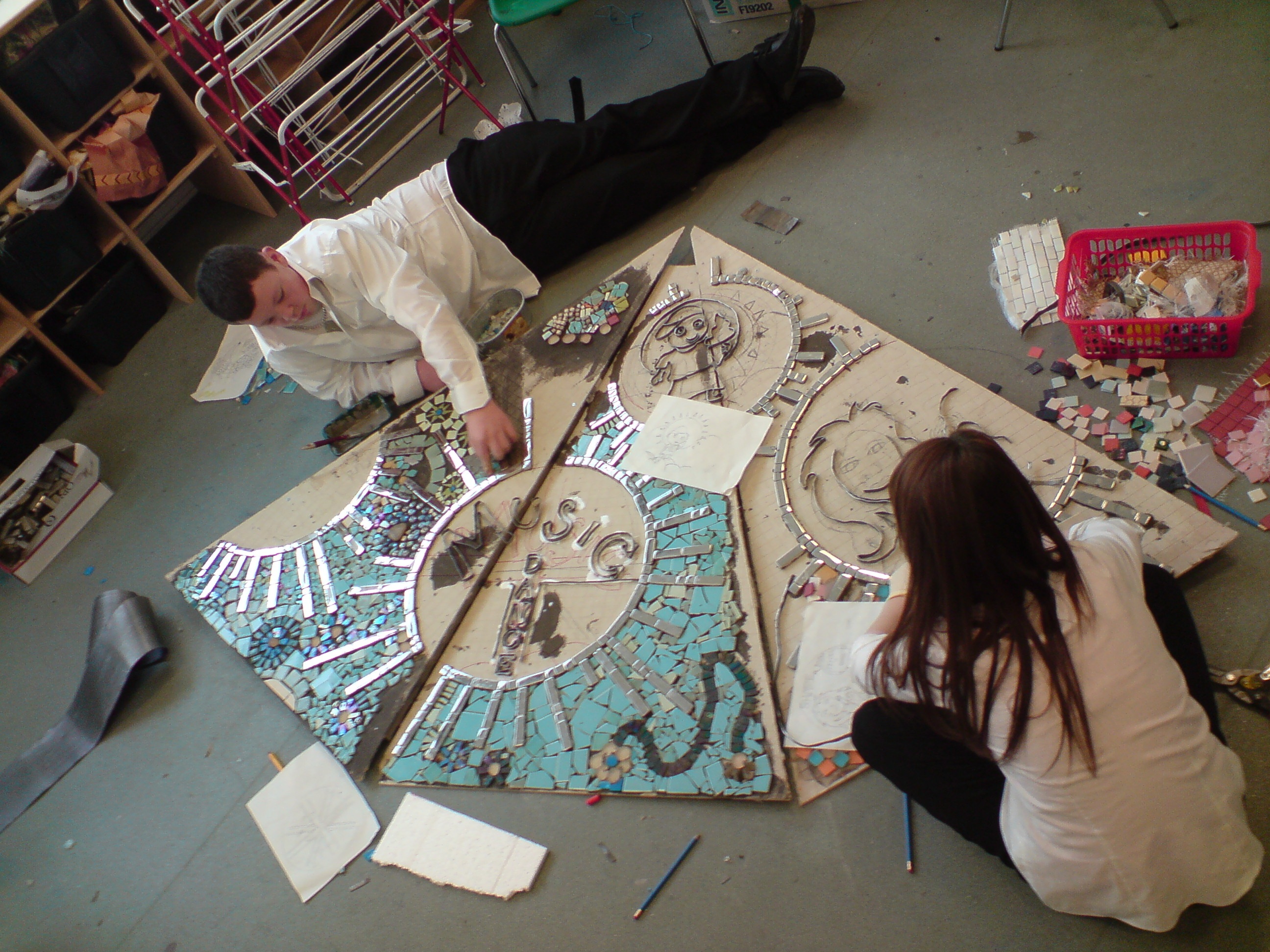 secondary children making a mosaic sat on the floor