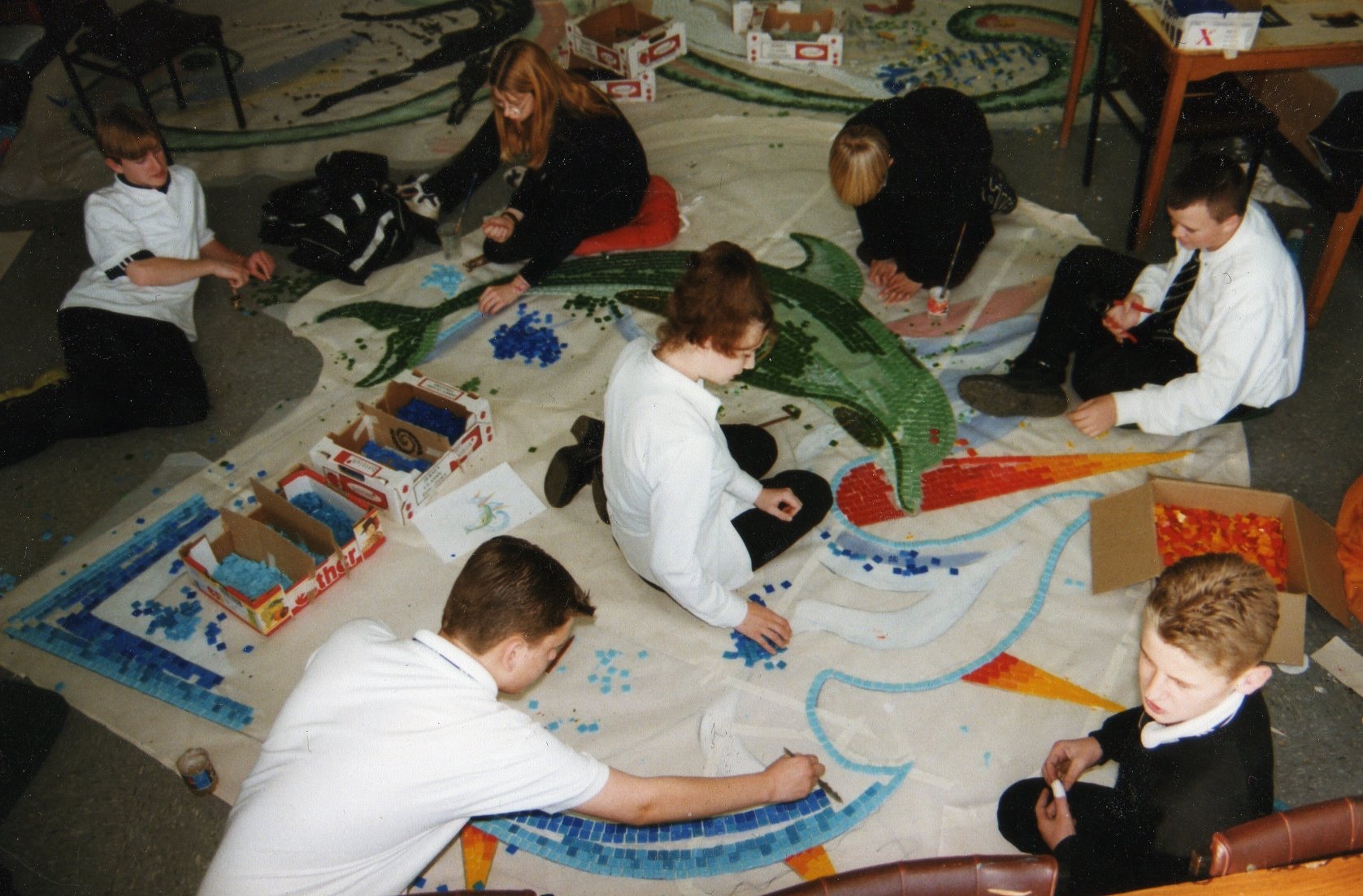 children making a mosaic of a dolphin