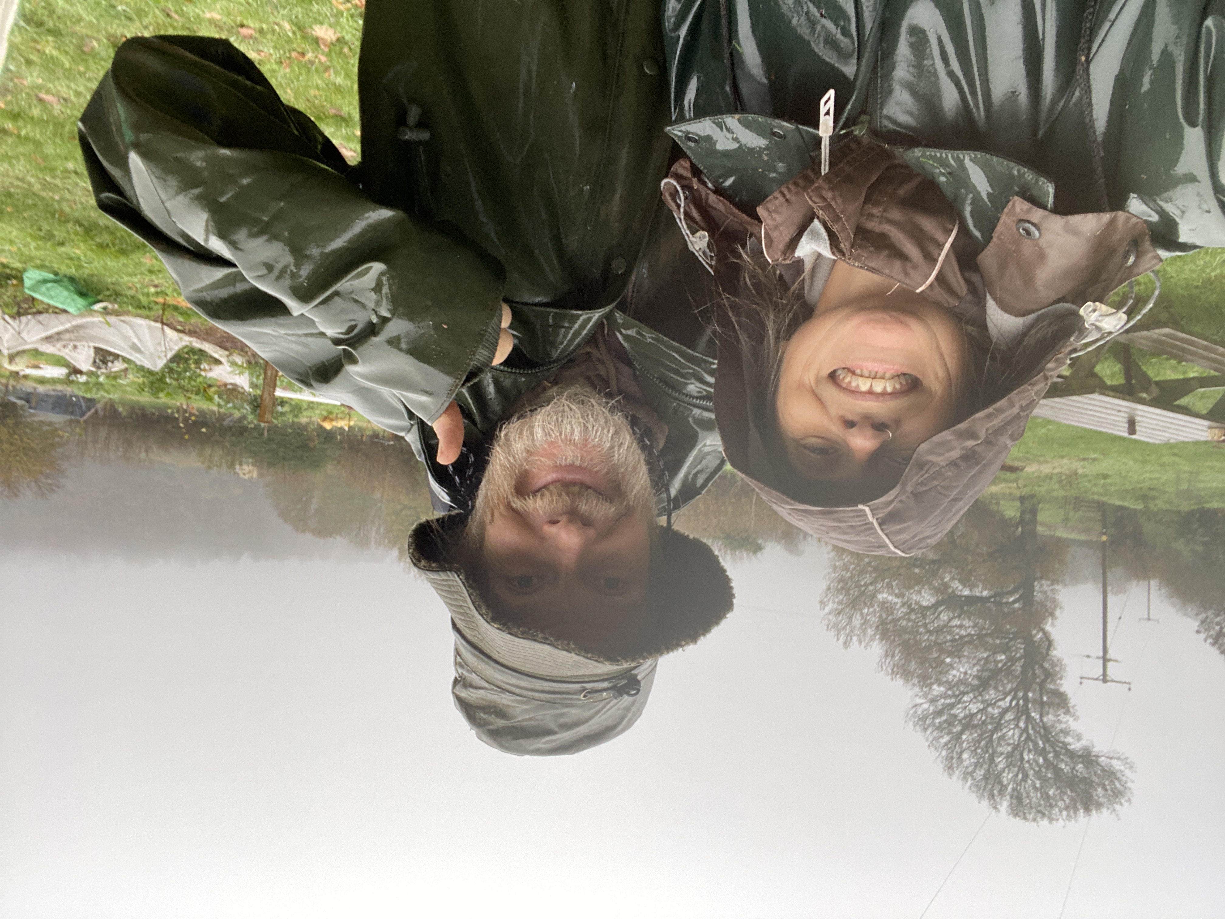 two happy people in wet weather gear